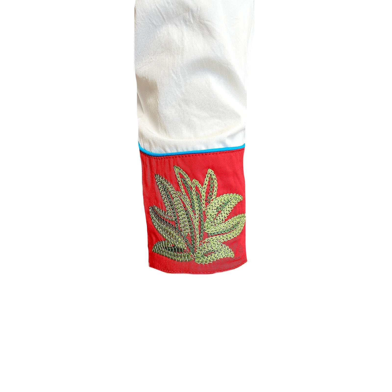 Ivory shirt with red embroidered collar and cuffs featuring cacti and stars. Cuff