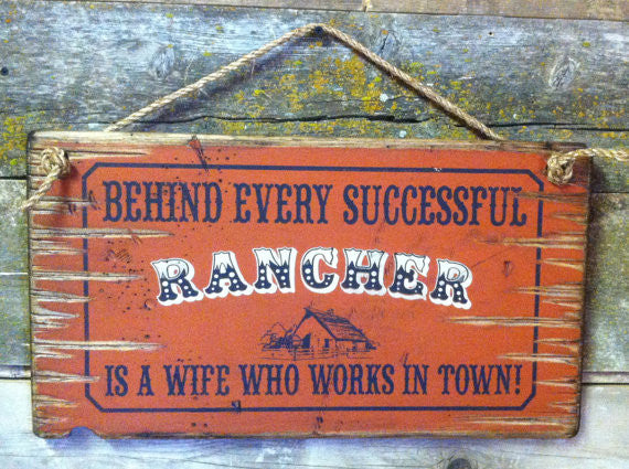 Old West Wooden Sign: Behind Every Rancher Is A Wife Who Lives In Town