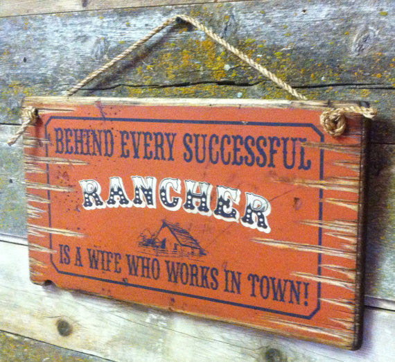 Old West Wooden Sign: Behind Every Rancher Is A Wife Who Lives In Town Right Side