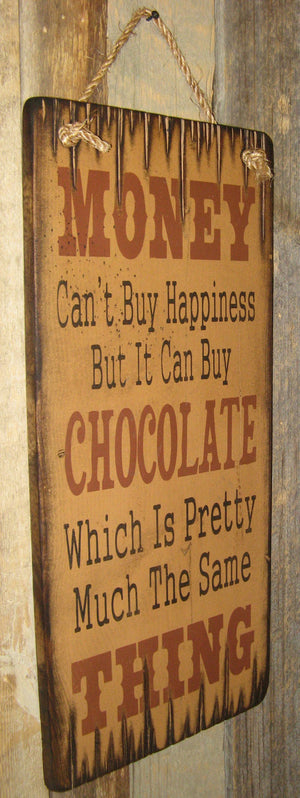 Western Wall Sign Money: Money Can't Buy Happiness But It Can Buy Chocolate Left View